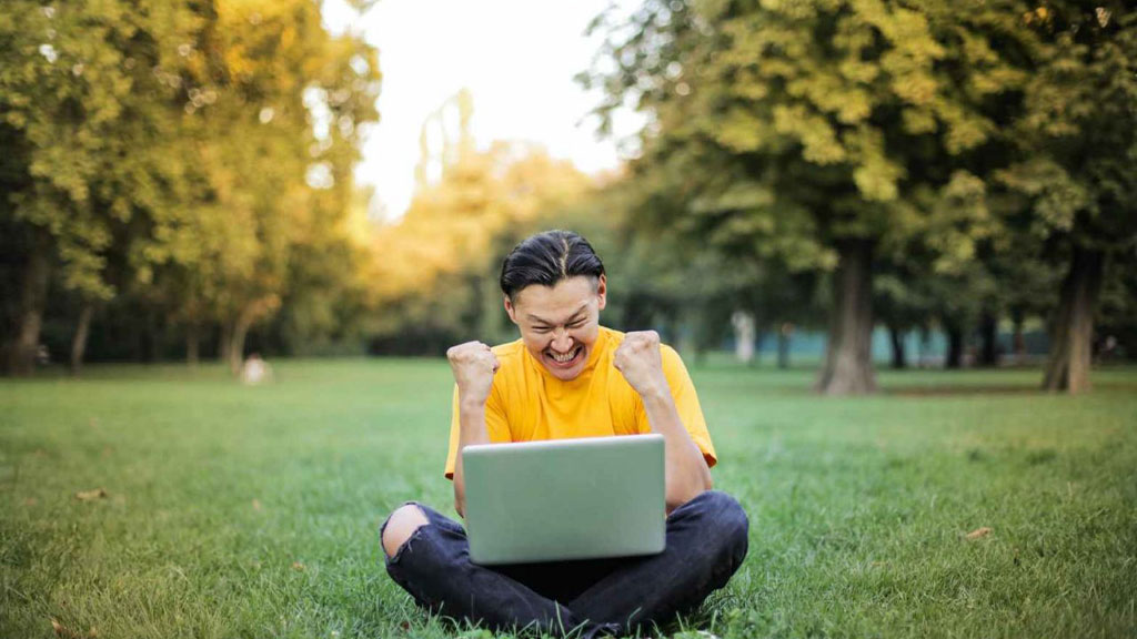 Student outside with laptop