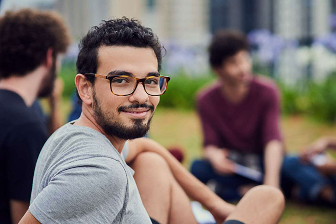 Campus male outside with friends