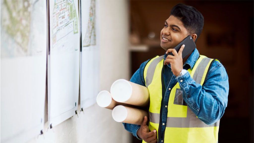 Male engineer working talking on phone