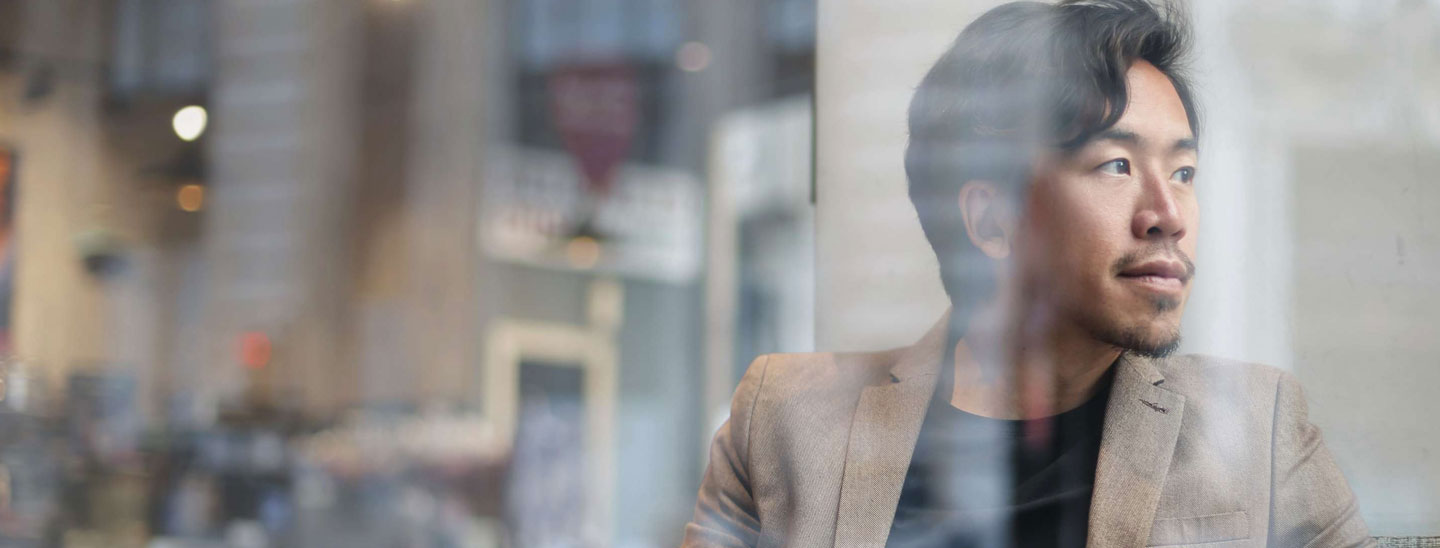 Man looking out window