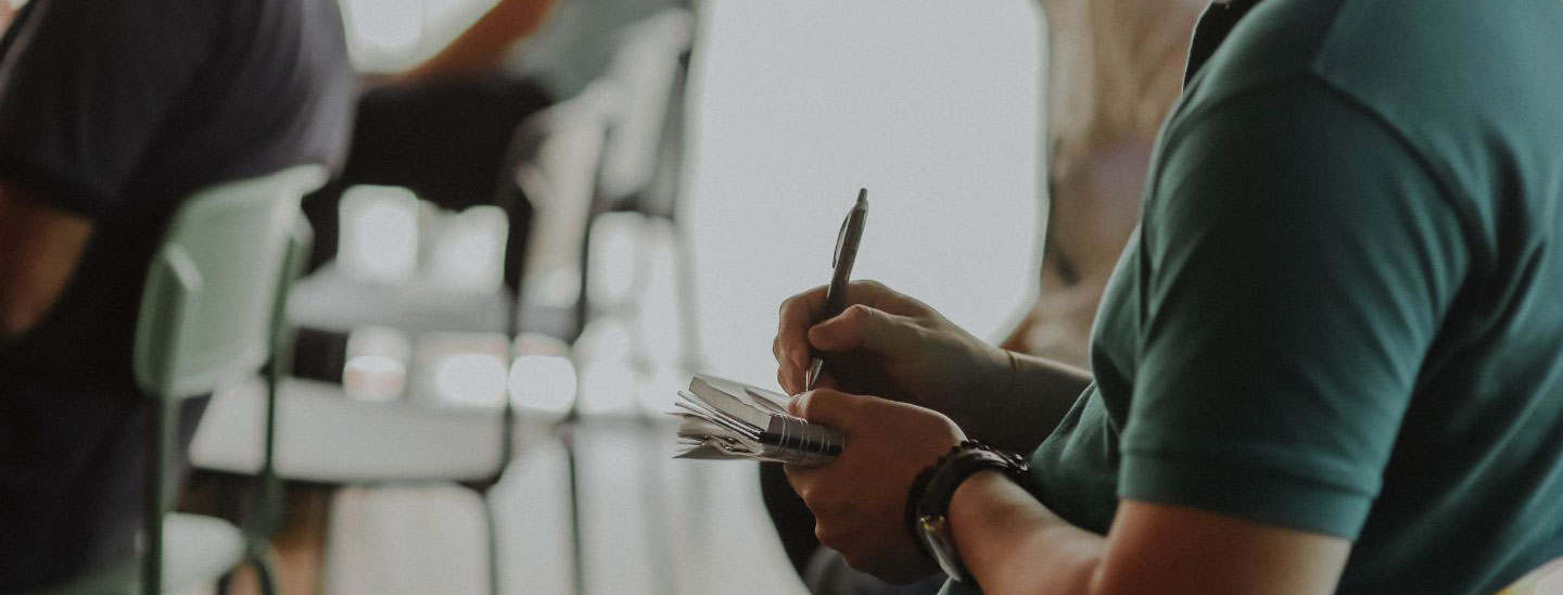 Man taking notes in meeting