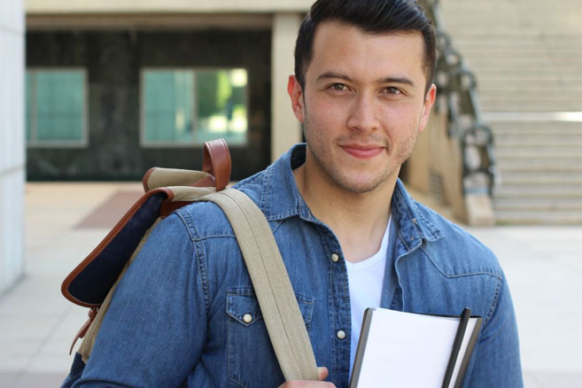 On campus student male with paper