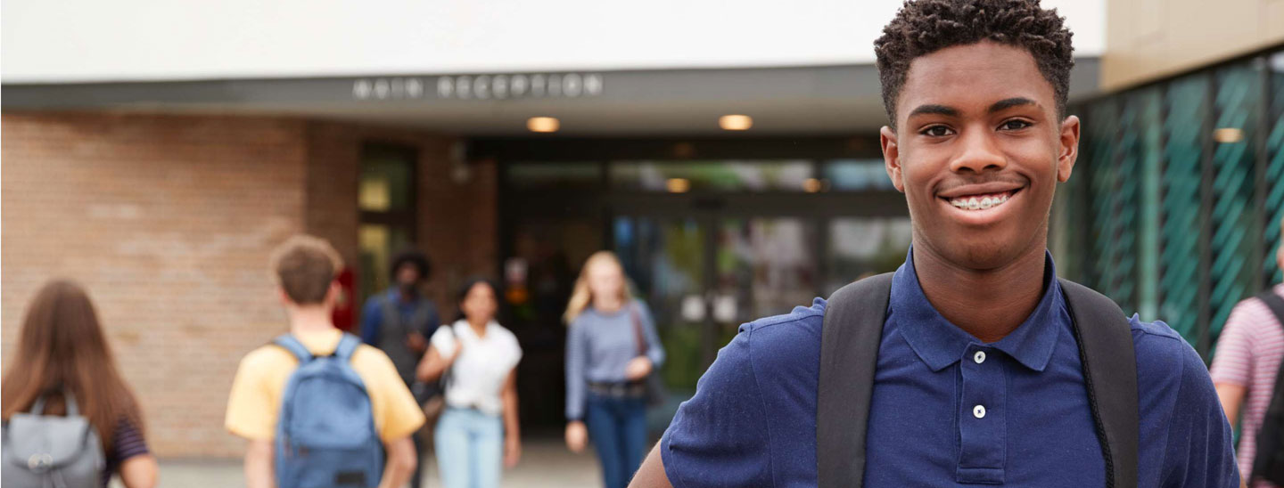 Student male with backpack on campus