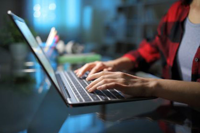 Student typing on computer