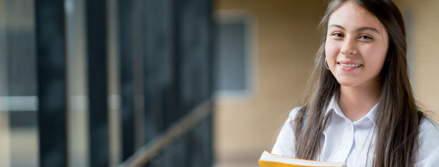 Student woman holding books smiling