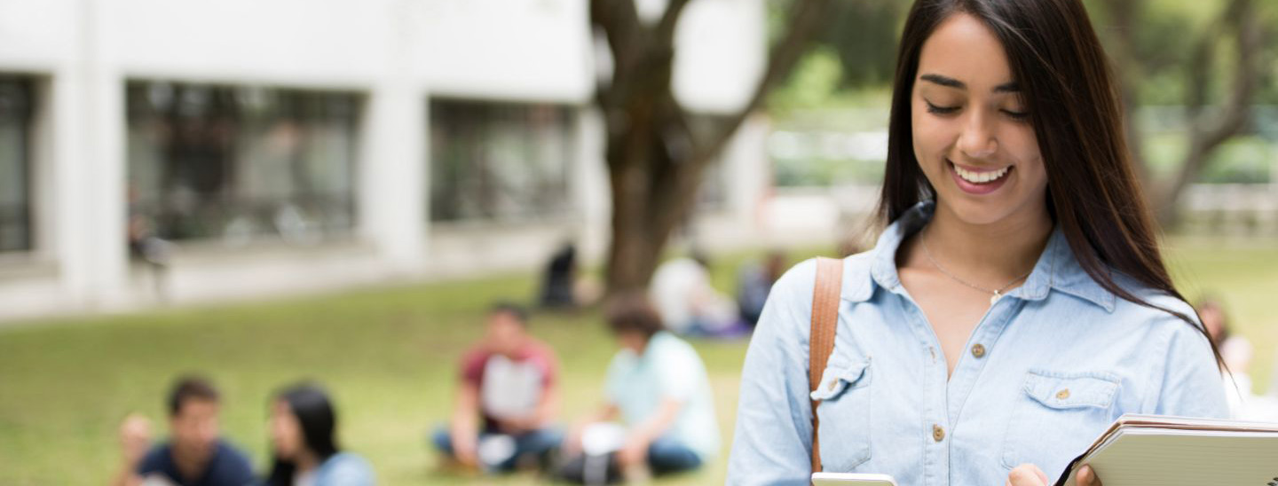 Student woman with books using phone