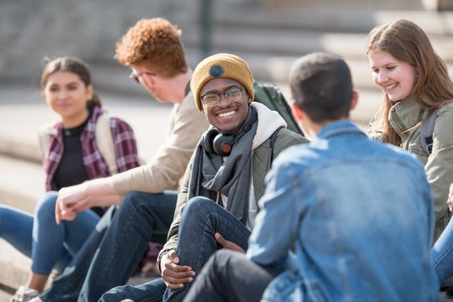 Students outside happy talking connecting