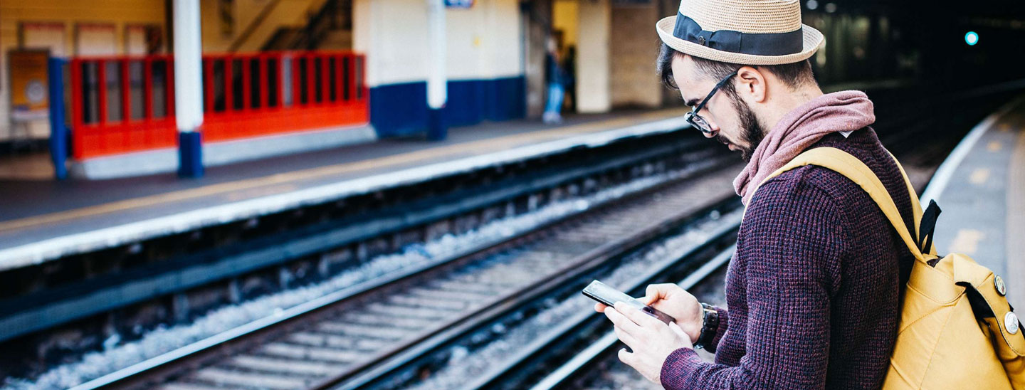 Train station man using phone