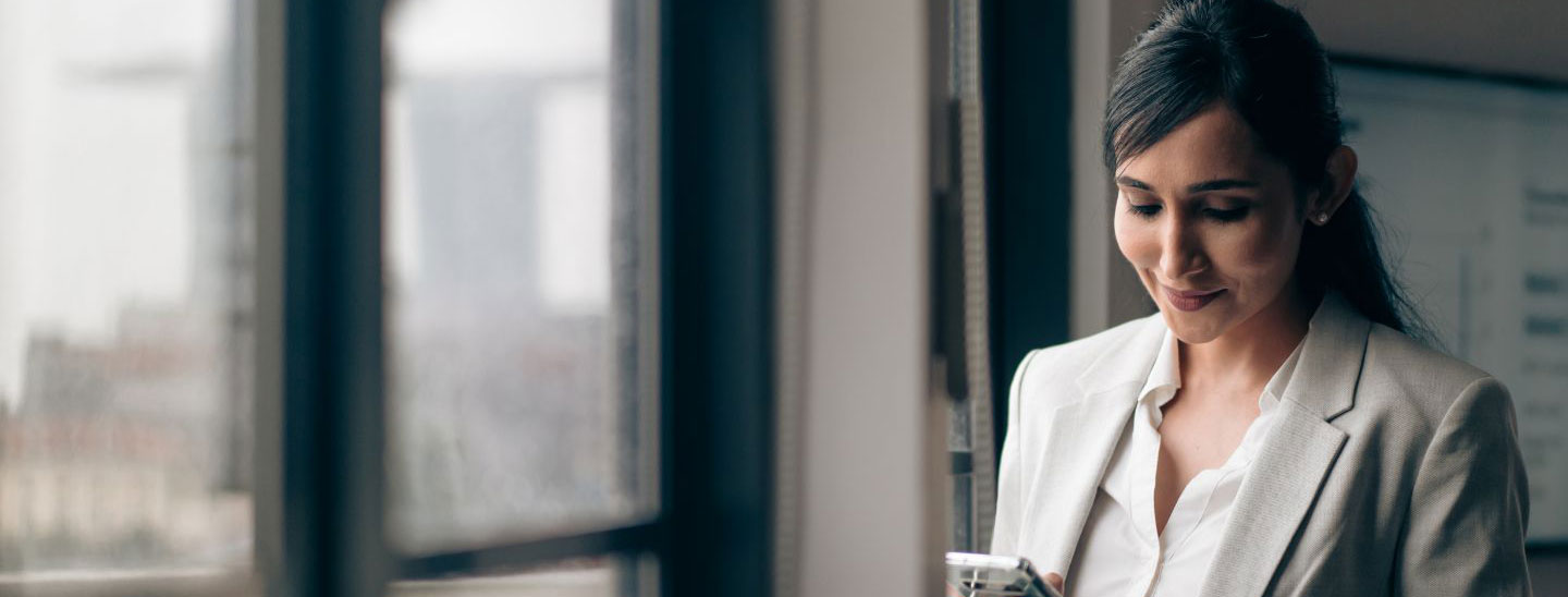 Woman using phone smiling